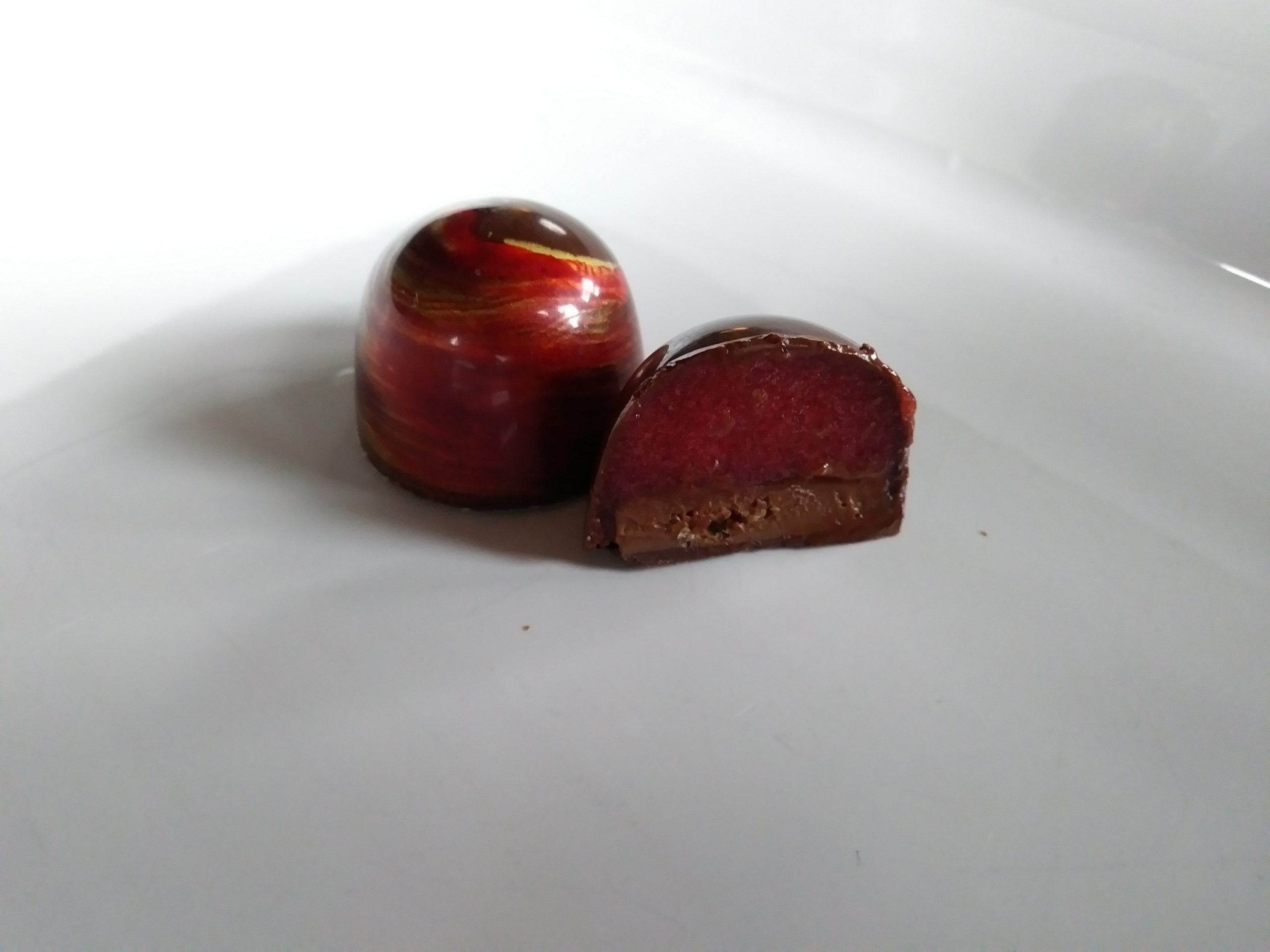 Tart raspberry jam compliments a creamy and crunchy peanut butter gianduja (a nut and chocolate blend). 